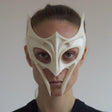 3D printed fantasy sculptural face mask with winged horn tips and elongated fang-like cheek points, open eye cutouts, worn in a clean studio portrait.