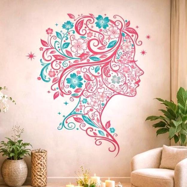 A minimalist illustration of a woman's profile facing right, created entirely from magenta and teal floral patterns. Her hair flows back in long, elegant swirls of vines, flowers, and leaves. The design is set against a clean white background with small sparkling star accents.