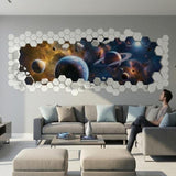 A horizontal 3D wall decal featuring a broken wall effect. The "outer" layer consists of white hexagonal tiles, some of which are floating as if broken off. The "opening" reveals a vibrant space scene with a large blue planet, a ringed Saturn-like planet, several smaller moons, and a colorful orange and blue nebula.