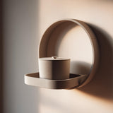 3D printed wall mounted memorial shelf with cylindrical urn in matte PLA featuring minimalist circular frame design on warm neutral wall.