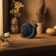 3D printed spiral snail sculpture featuring a snail with a prominent coiled shell and simple antennae