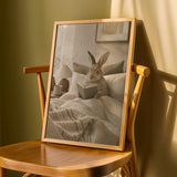 Californian Rabbit Reading in Bed Poster | Modern Gouache Bunny Wall Art | Warm Beige Oat Milk Decor | Cozy Scandinavian Bedroom Print