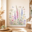 Watercolor wall vinyl decal of a wildflower meadow with pink and purple foxgloves, blue blooms, daisies, delicate greenery, and small butterflies on a white background.