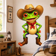 Bright green cartoon frog wearing a large brown cowboy hat with a sheriff badge, red neckerchief, and cowboy boots, standing with hands on hips.