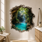 Realistic tropical waterfall flowing into a bright turquoise lagoon surrounded by rocky cave walls and lush green foliage, framed by a rugged broken-wall effect.