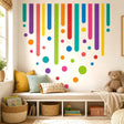 Abstract design with colorful rounded vertical bars and scattered circles in teal, purple, pink, red, orange, yellow, green, and blue on a white background.