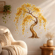 Watercolor-style tree with a curved brown trunk, cascading golden-yellow and amber leaves, and several individual falling leaves against a white background.