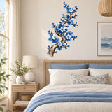 Botanical wall sticker of a winding branch covered with blue flowers, white blossoms and unopened buds.