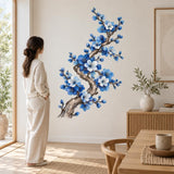 Blue blossom wall art featuring a twisting brown tree branch with cobalt flowers and white floral highlights.