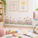 Floral meadow decal featuring scattered butterflies and bright wildflowers along the lower part of a room wall.