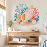Beach-themed vinyl wall art with cream seashells, colorful coral, an orange starfish and sandy ocean details.