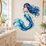 Large blue mermaid wall decal with flowing turquoise tail on a light bathroom wall beside a sink and woven towel shelf.