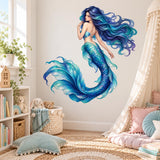 Blue and turquoise mermaid wall decal with flowing hair and curled tail above toys and soft cushions in a bright child's bedroom.