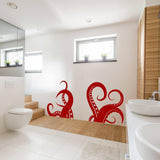 Red octopus vinyl wall sticker in a stylish bathroom, adding a marine theme decoration.
