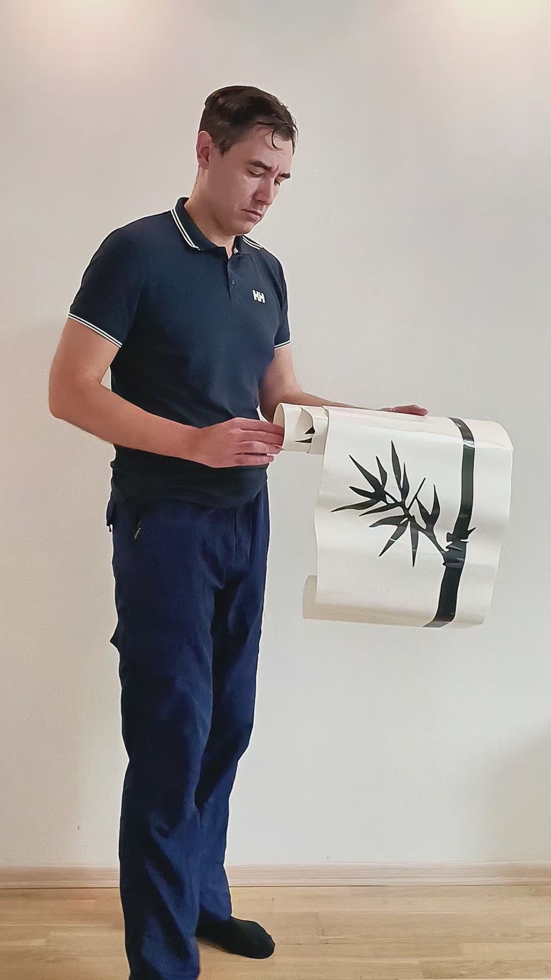 Person applying a Bamboo Wall Art vinyl sticker for nature-inspired home decor.