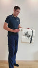 Person applying a Bamboo Wall Art vinyl sticker for nature-inspired home decor.