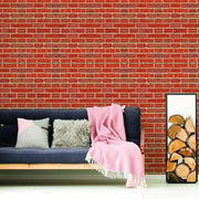 Cozy living room featuring a brick wall, soft pillows, and a pink throw blanket.