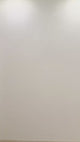 Empty wall with soft lighting, perfect for showcasing wall art or decorations.