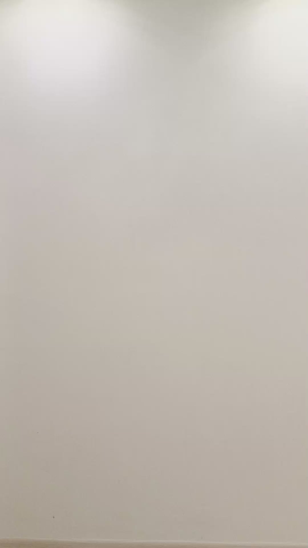 Empty wall with soft lighting, perfect for showcasing wall art or decorations.