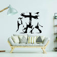 Banksy-inspired elephant graffiti vinyl sticker on living room wall above modern sofa with decorative cushions.