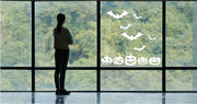 Pumpkin and bat vinyl window decals displayed as a coordinated seasonal set.