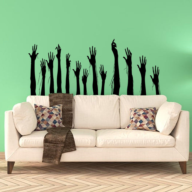 Hand silhouette vinyl decals arranged above a sofa for a seasonal wall display.